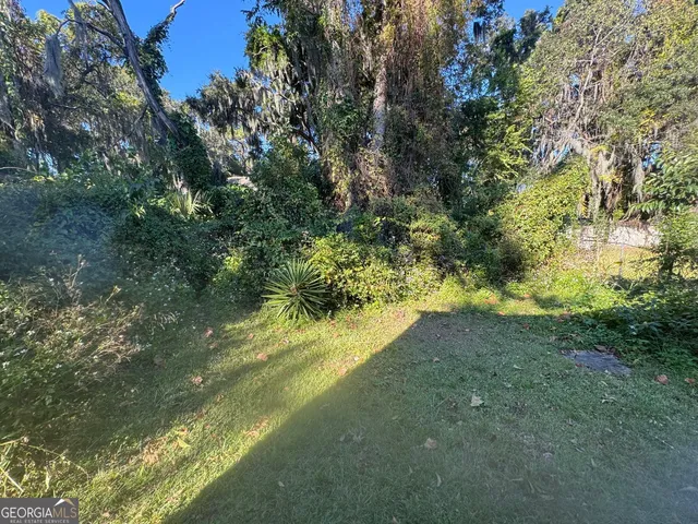 a brick building with a small yard and a large window