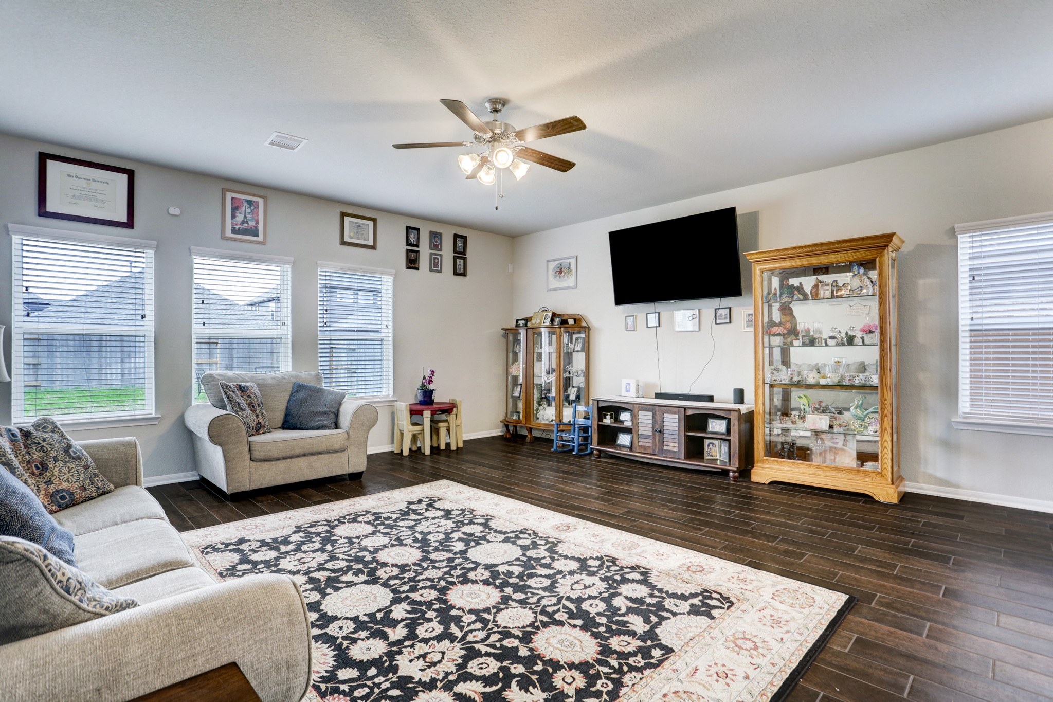 5414 Rustic Ruby Drive Fulshear, TX 77423 - Photo 2 of 26 Family Room features wood look the floors for super easy care. The triple windows let in lots of natural light.