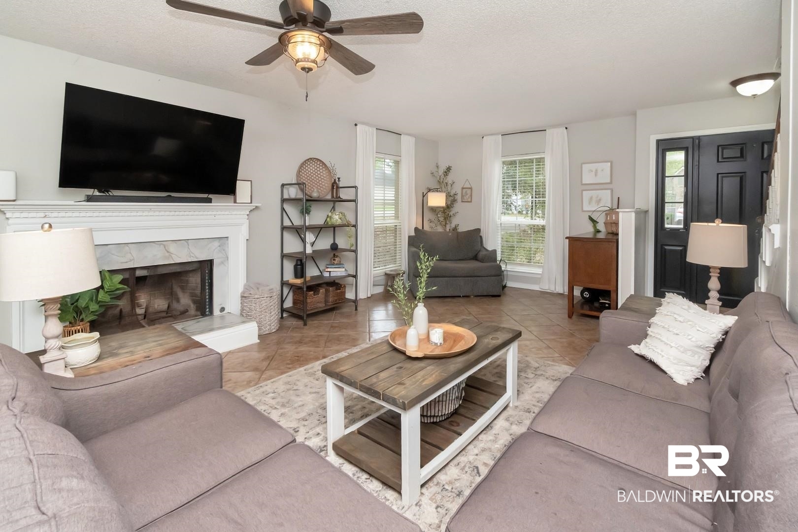 1065 Linlen Avenue Mobile, AL 36609 - Photo 5 of 31 Living area featuring tile patterned floors, a high end fireplace, a textured ceiling, and a ceiling fan