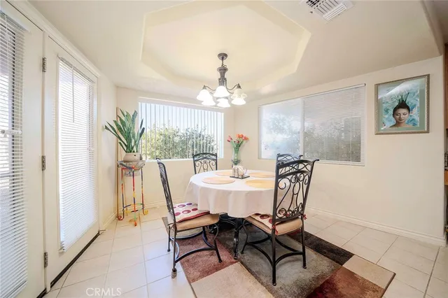 a view of a dining room with furniture and a chandelier