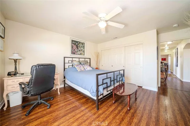 a bedroom with a bed and a chair