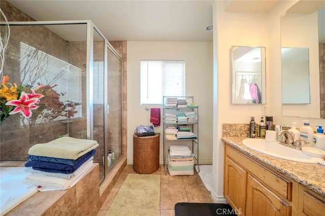 a bathroom with a sink mirror and a shower
