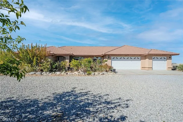 a view of a house with a yard and mountain in the background