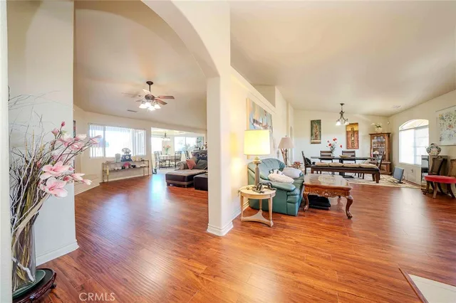 a living room with fireplace furniture and a wooden floor