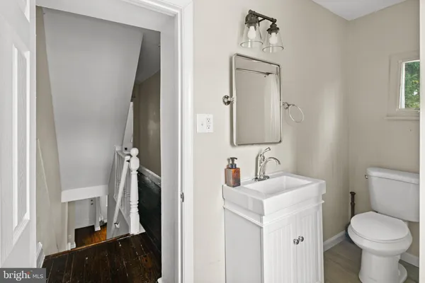 a bathroom with a toilet sink and mirror