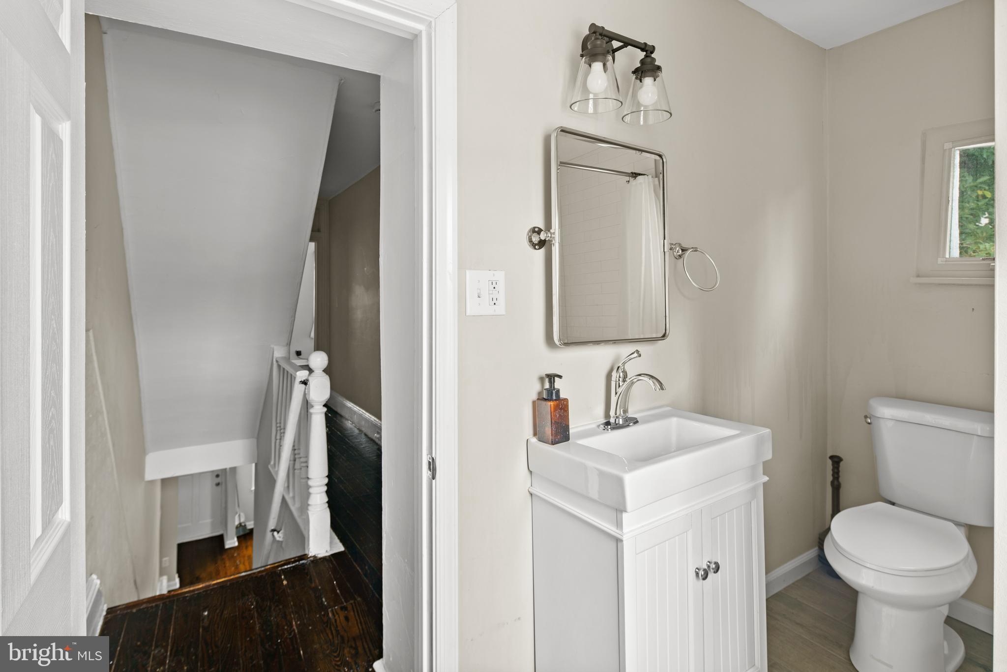 127 Seville Street Philadelphia, PA 19127 - Photo 17 of 23 a bathroom with a toilet sink and mirror