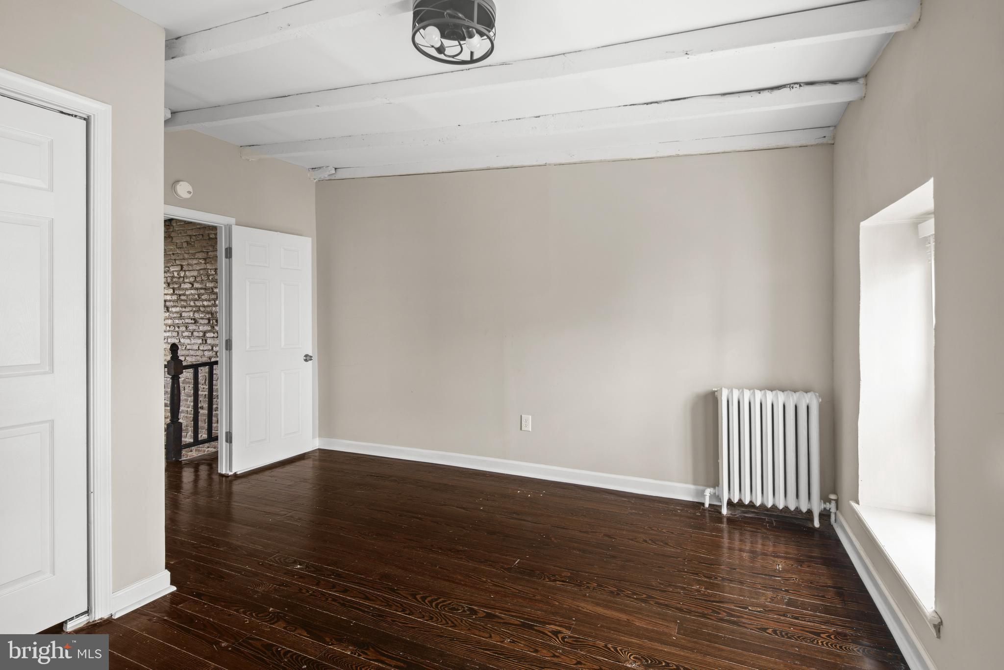 127 Seville Street Philadelphia, PA 19127 - Photo 19 of 23 a view of an empty room with wooden floor and a window