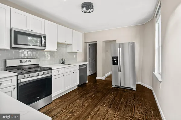a kitchen with a stove and a refrigerator