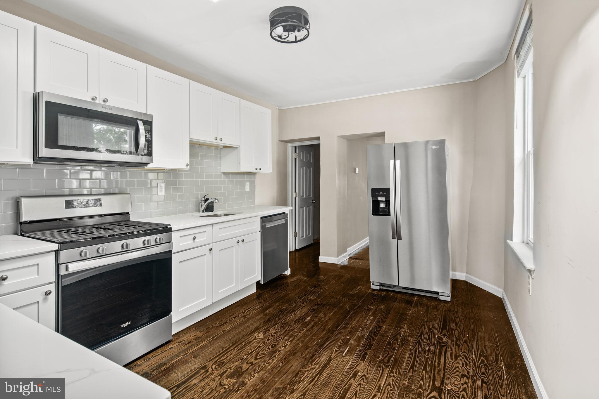 127 Seville Street Philadelphia, PA 19127 - Photo 2 of 23 a kitchen with a stove and a refrigerator