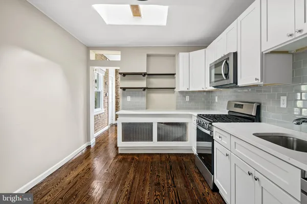 a kitchen with a stove and a refrigerator