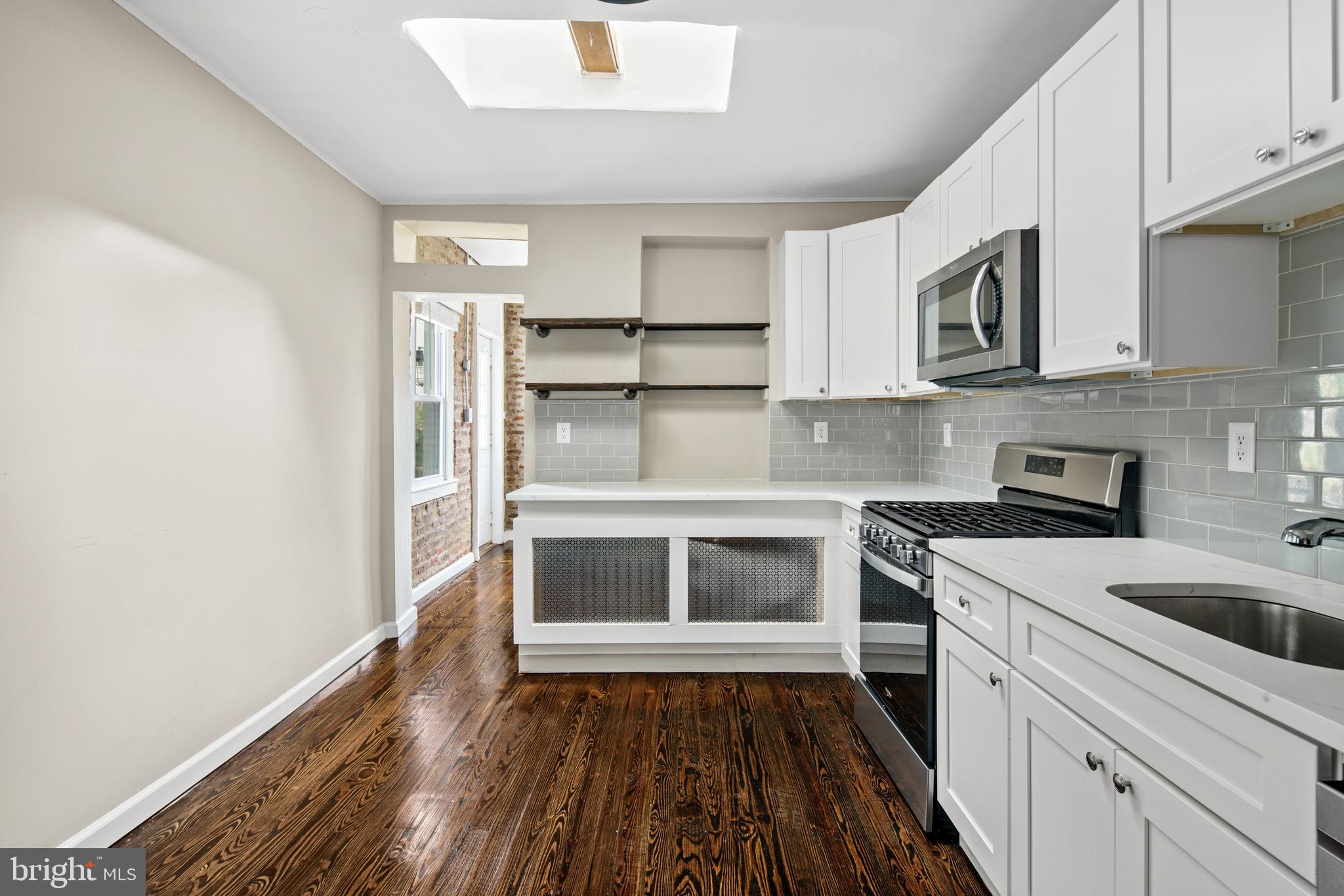 127 Seville Street Philadelphia, PA 19127 - Photo 3 of 23 a kitchen with a stove and a refrigerator