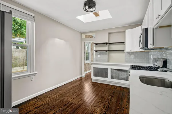 a kitchen with a refrigerator and a sink