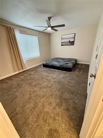 a view of a livingroom with wooden floor and a window