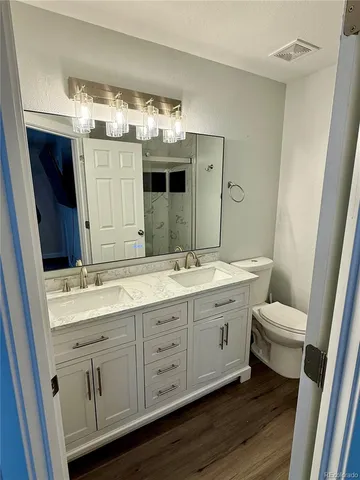 a bathroom with a double vanity sink and a mirror