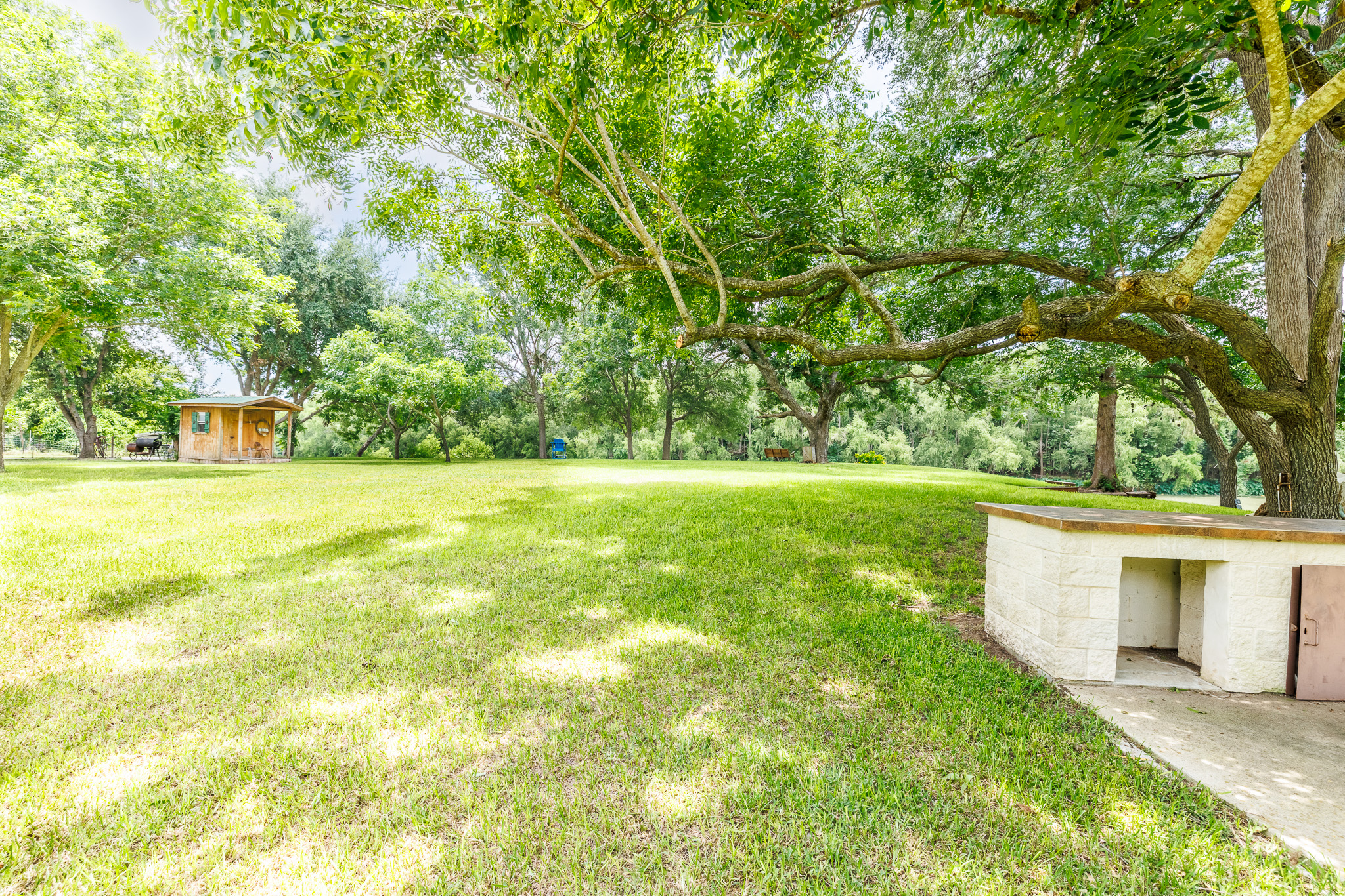Tbd Goodwin Road Gonzales, TX 78629 - Photo 7 of 33 A tranquil, spacious yard boasts mature shade trees and a quaint shed.