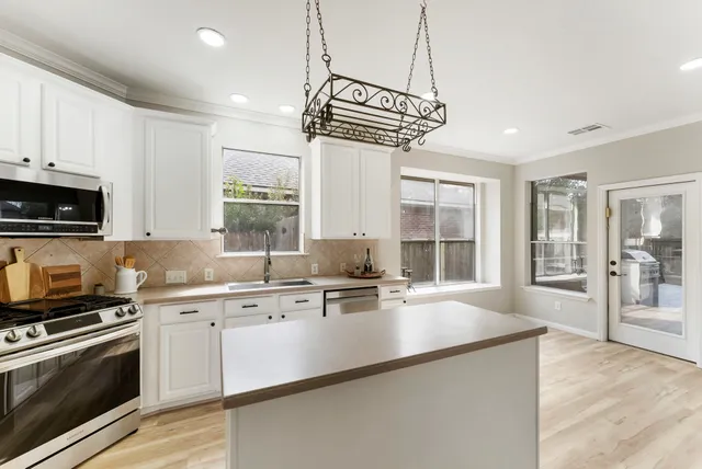 a kitchen with a sink stove and microwave