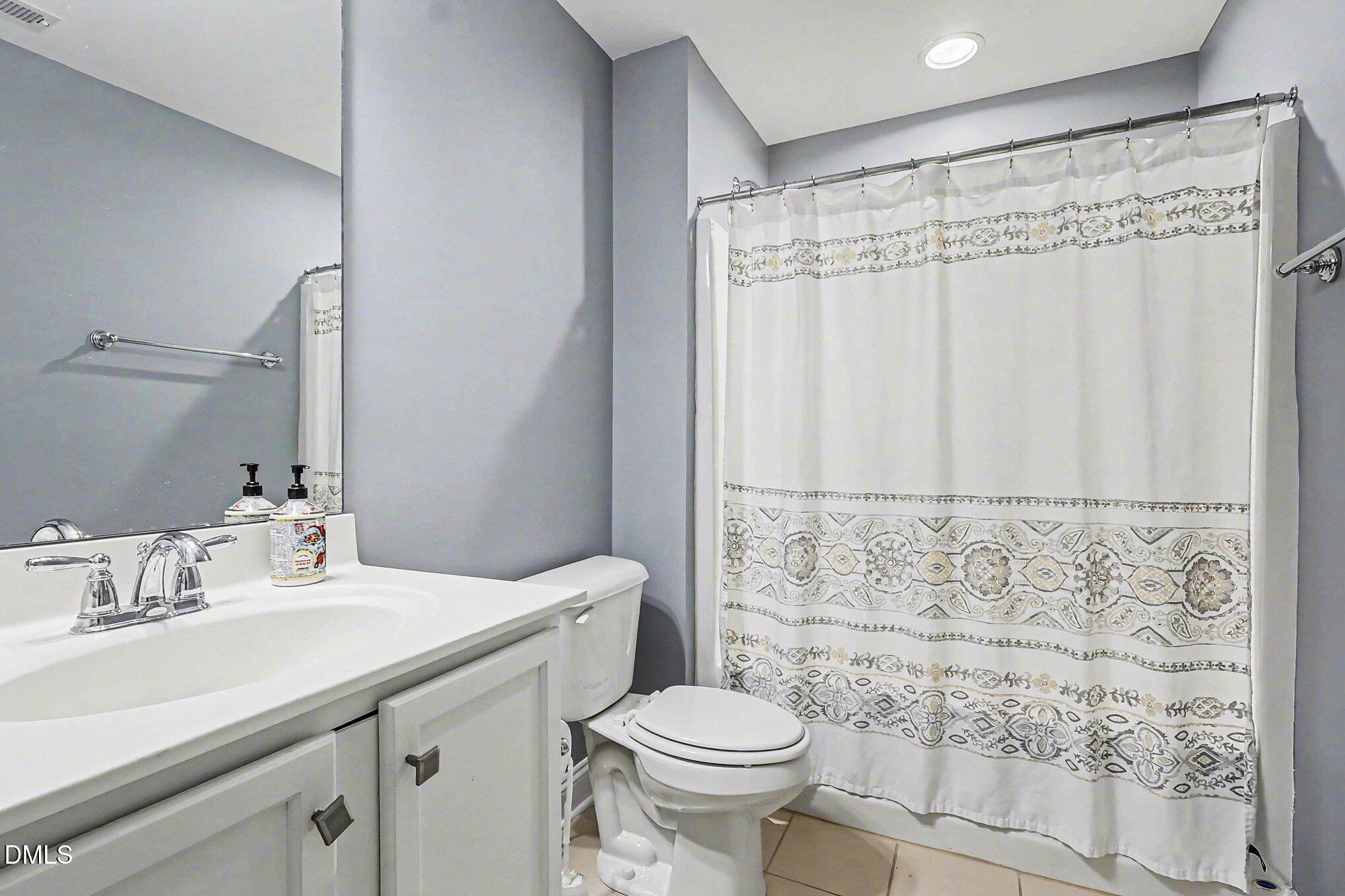 653 Fallon Grove Way Raleigh, NC 27608 - Photo 14 of 38 a bathroom with a sink toilet and shower