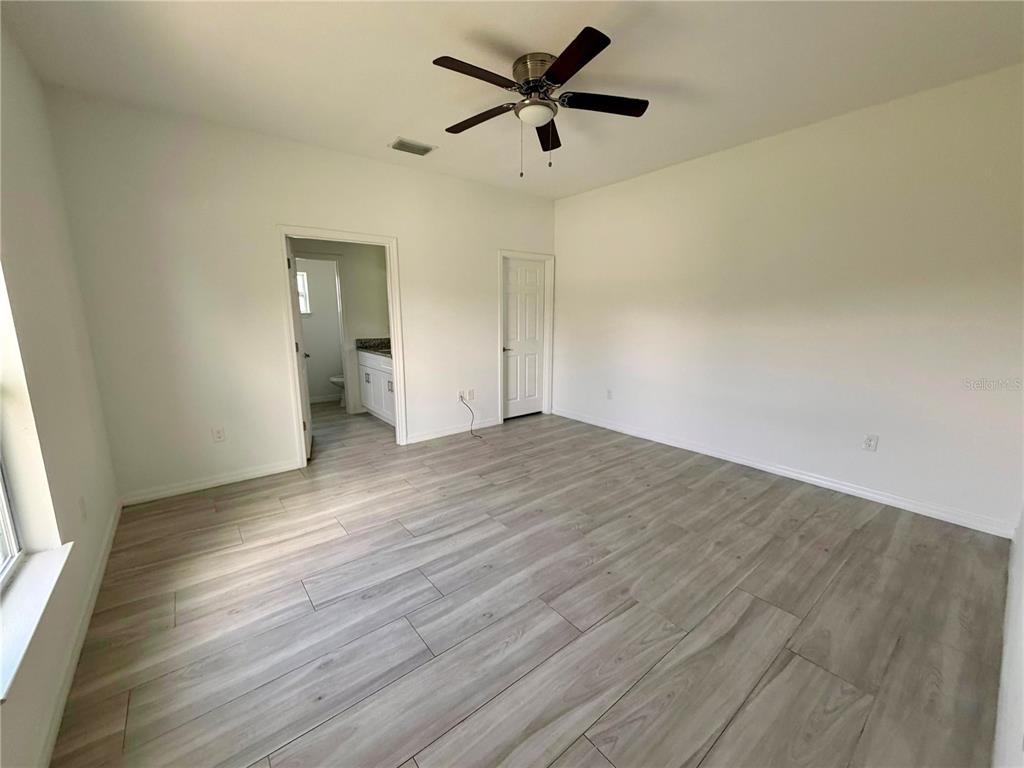14142 Appleton Boulevard Port Charlotte, FL 33981 - Photo 10 of 26 a view of empty room with wooden floor