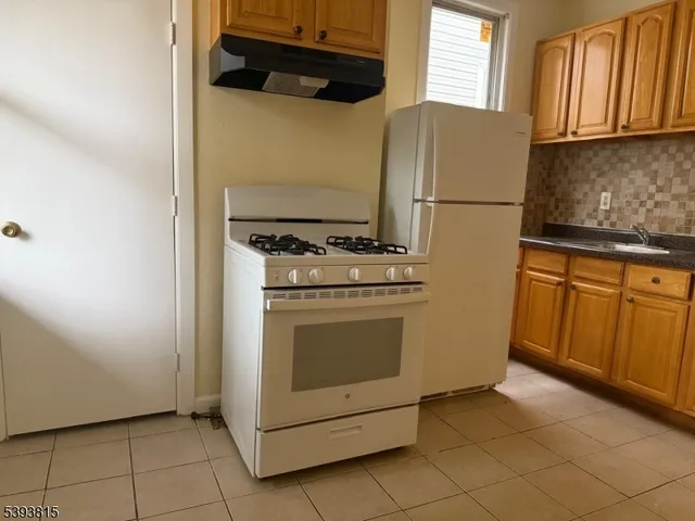a stove top oven sitting inside of a kitchen