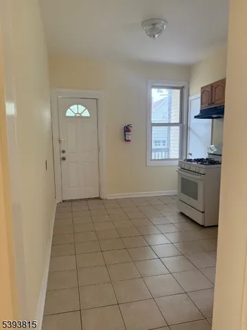 a view of a kitchen with microwave and windows