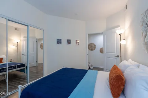 a bedroom with a bed and a mirror