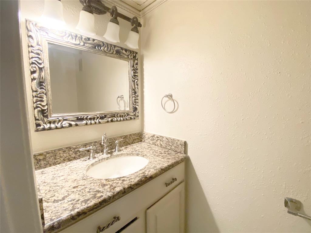 4505 North O'Connor Road, Unit 1122 Irving, TX 75062 - Photo 12 of 18 a bathroom with a granite countertop sink and a mirror