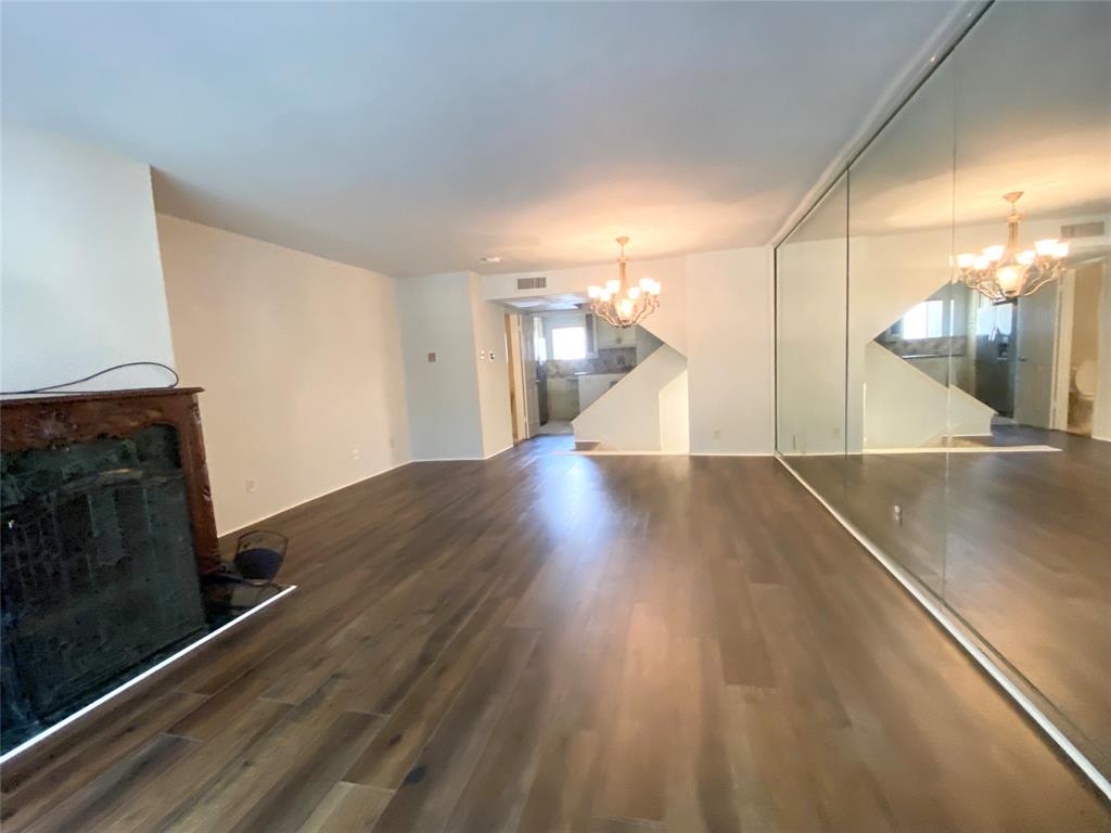 4505 North O'Connor Road, Unit 1122 Irving, TX 75062 - Photo 4 of 18 a view of a living room a wooden floor and a fireplace