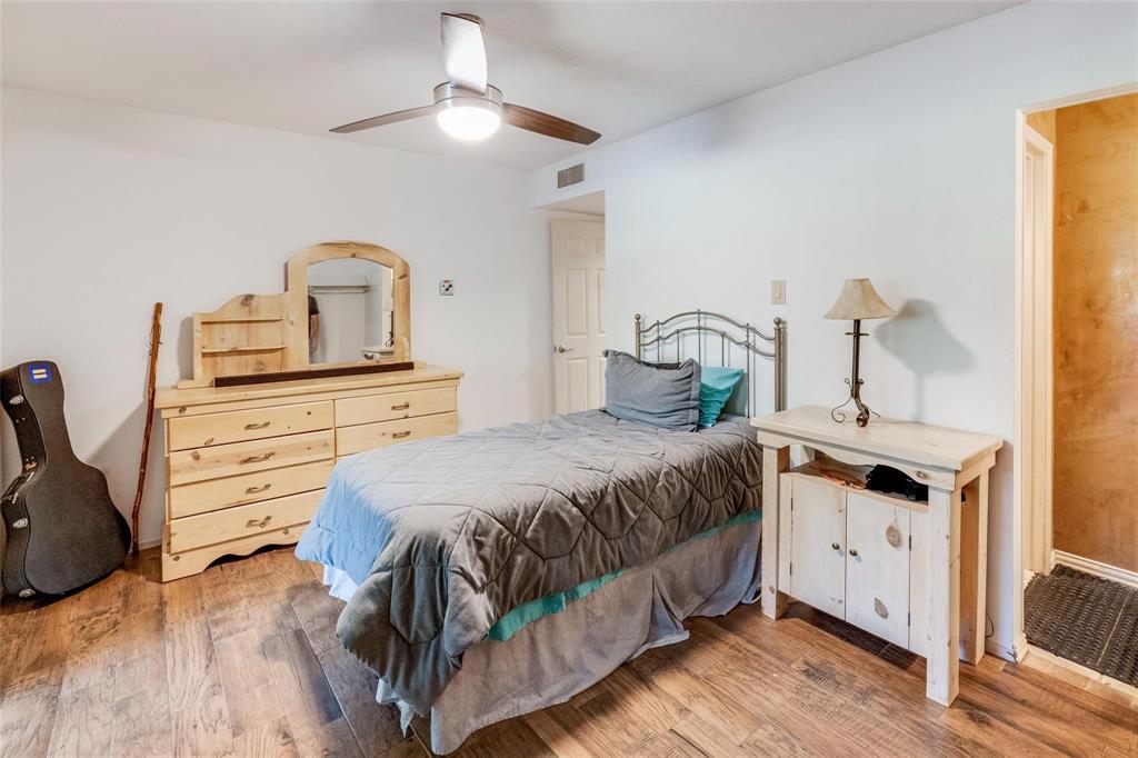 4505 North O'Connor Road, Unit 1122 Irving, TX 75062 - Photo 7 of 18 a bedroom with a bed and wooden floor