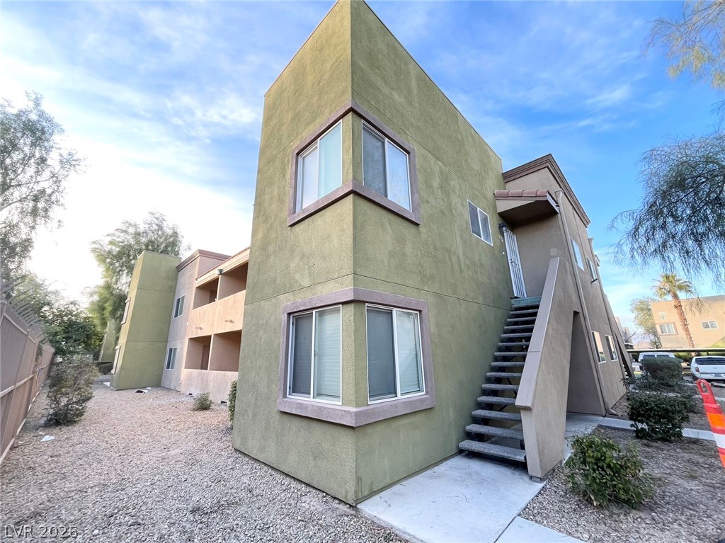 1834 North Decatur Boulevard, Unit 204 Las Vegas, NV 89108 - Photo 1 of 17 A striking exterior presents a multi-level structure with a stucco finish and accessible outdoor stairs.