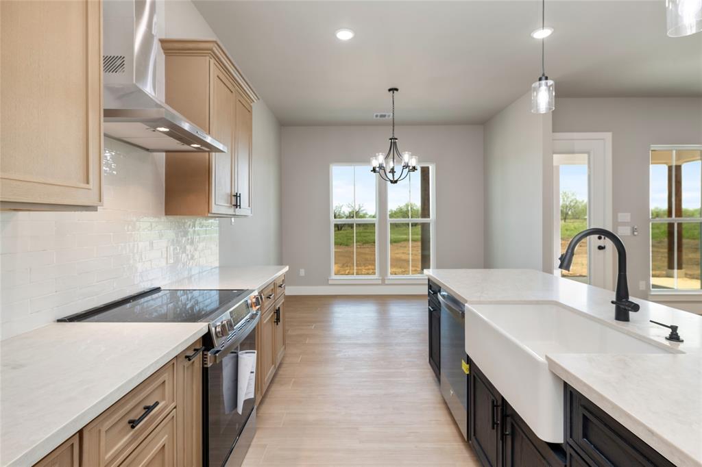 217 Fm 2258 Venus, TX 76084 - Photo 12 of 36 a kitchen with kitchen island a sink appliances and a counter top space