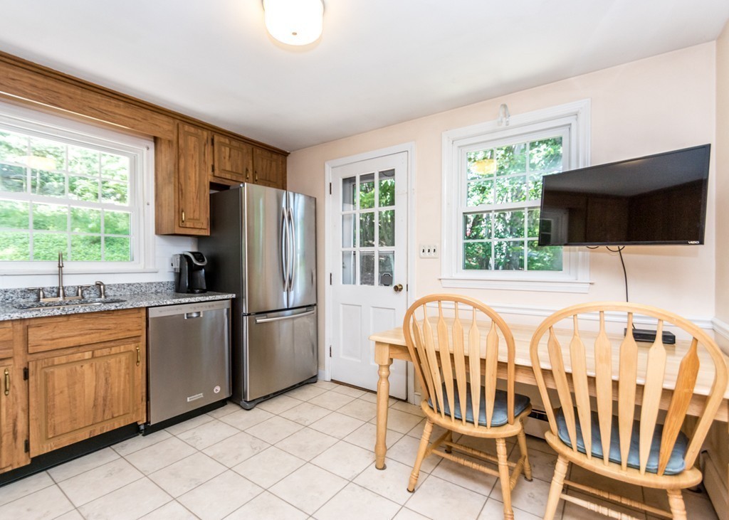 166 Totten Pond Road Waltham, MA 02451 - Photo 4 of 29 a kitchen with a sink a stove and a refrigerator