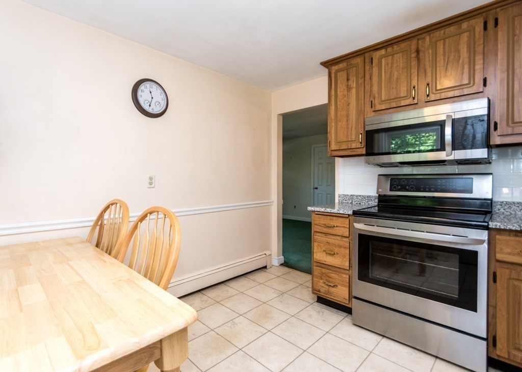 166 Totten Pond Road Waltham, MA 02451 - Photo 6 of 29 a kitchen with stainless steel appliances granite countertop a stove top oven a sink and dishwasher