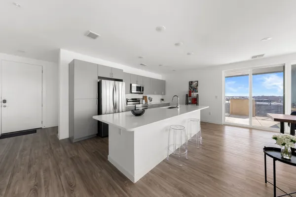 a kitchen with sink and refrigerator