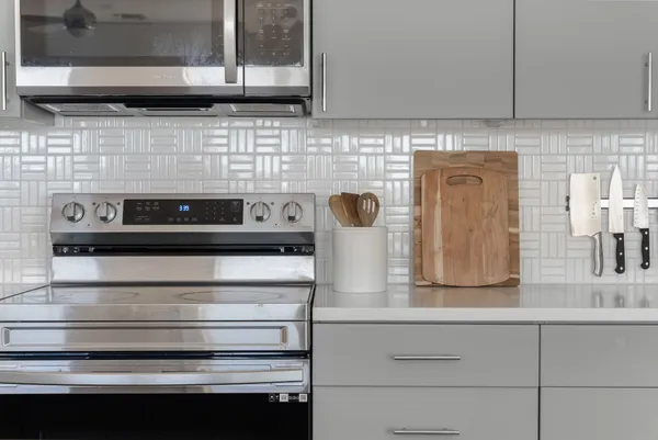 a kitchen with kitchen island a sink stainless steel appliances and cabinets