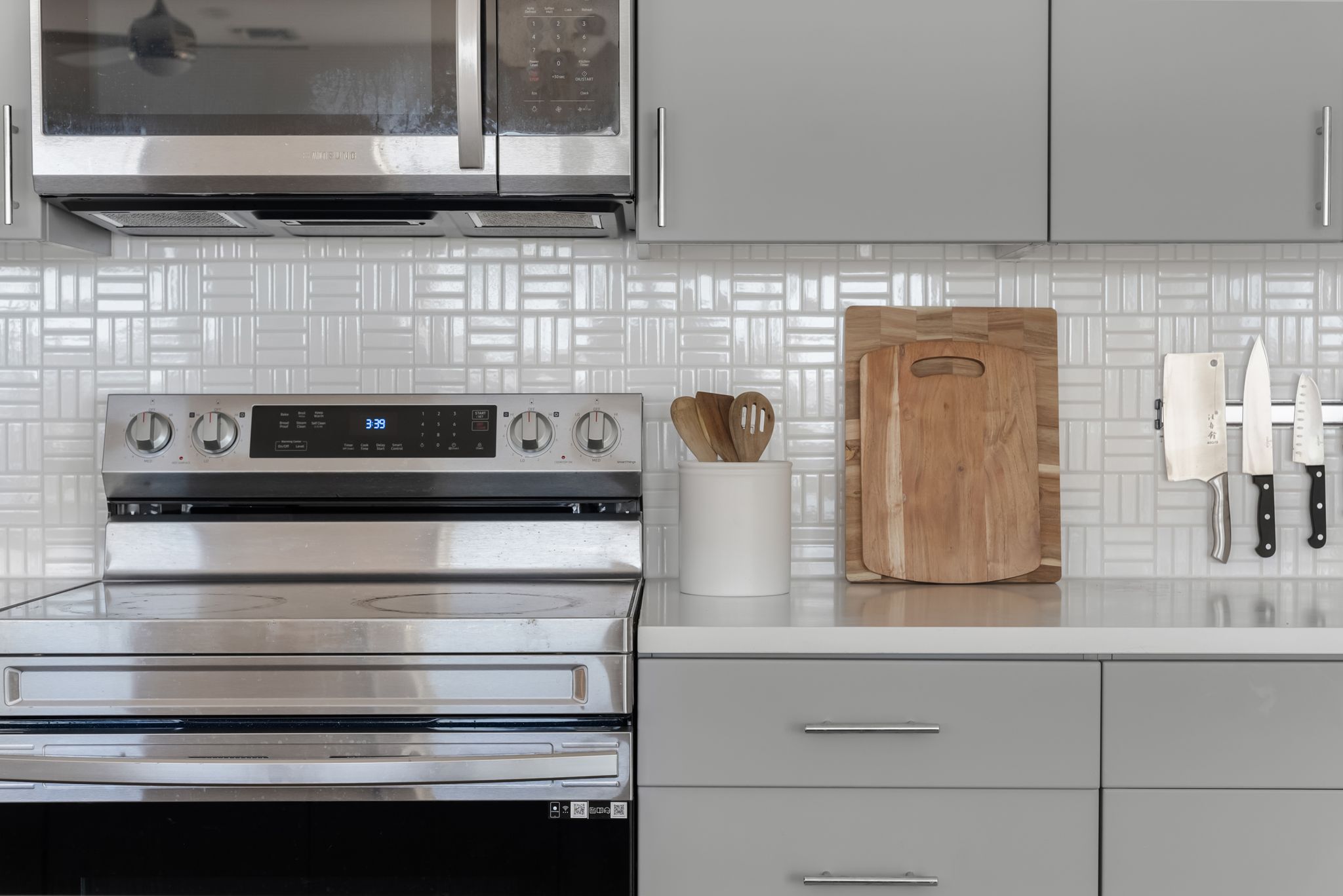 4801 Springdale Road, Unit 2410 Austin, TX 78723 - Photo 13 of 33 a kitchen with white cabinets and appliances
