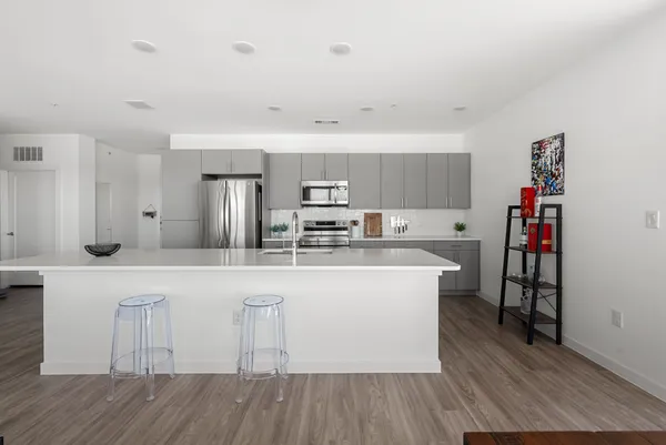 a kitchen with white cabinets and appliances