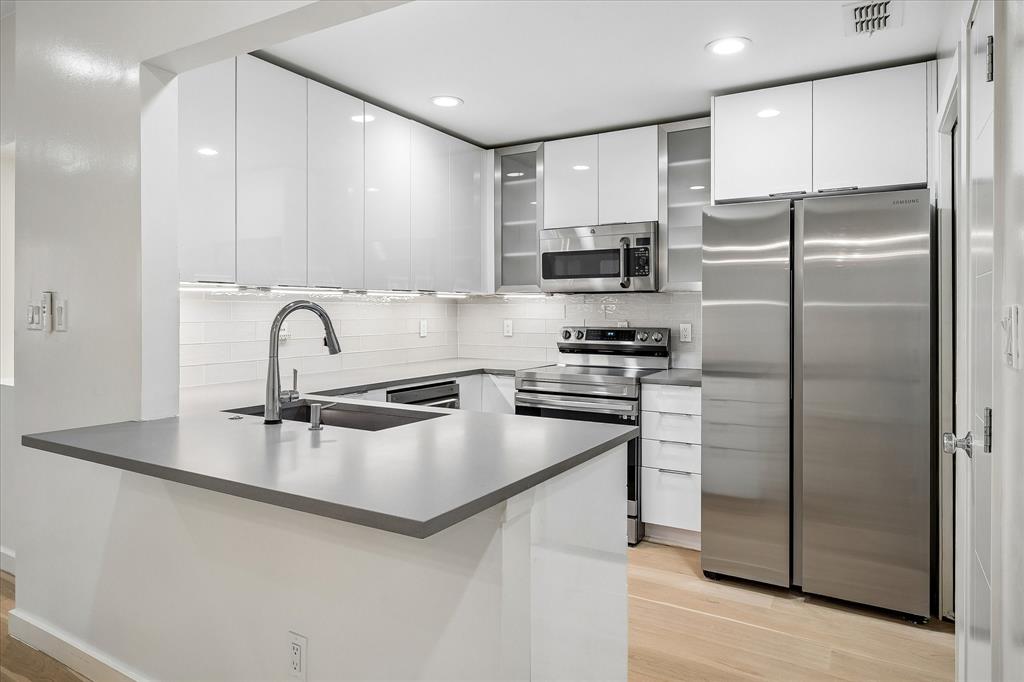 12680 Hillcrest Road, Unit 1109 Dallas, TX 75230 - Photo 8 of 22 Completely updated kitchen with Kitchen Kraft acrylic cabinets. Refrigerator conveys with the property.