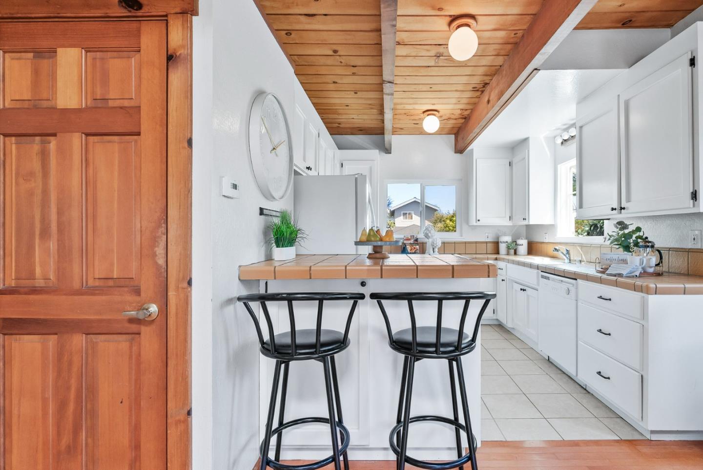 620 Sumner Street Santa Cruz, CA 95062 - Photo 9 of 45 a kitchen with stainless steel appliances a table chairs and cabinets