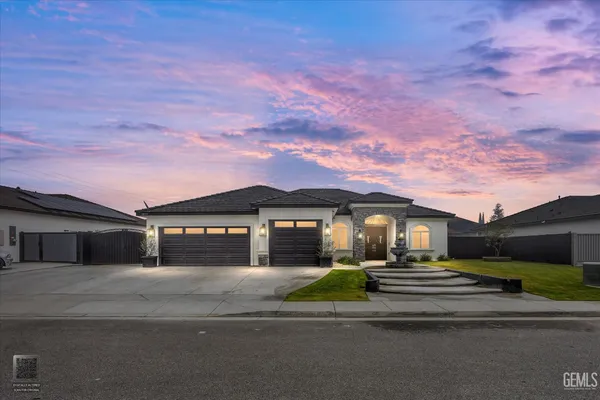a front view of a house with a yard and outdoor seating