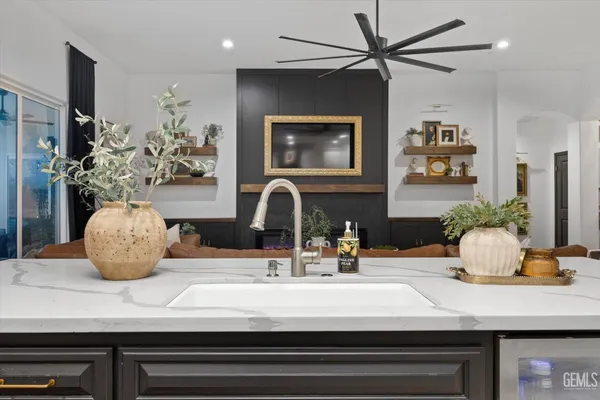 a white bed sitting in a bedroom next to a window