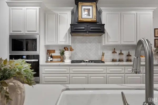 a bathroom with a granite countertop sink a toilet and a mirror