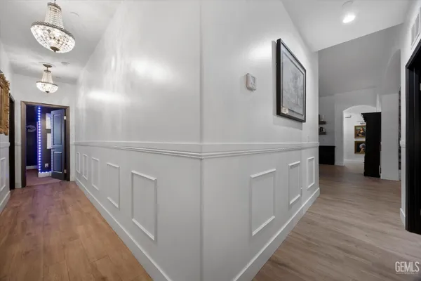 a bedroom with a bed a wall painting and a book shelf