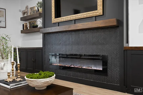 a room with a fireplace and chandelier