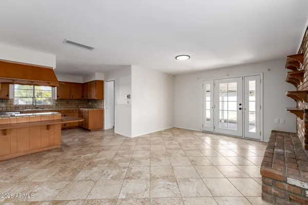 a large kitchen with stainless steel appliances granite countertop a sink and cabinets