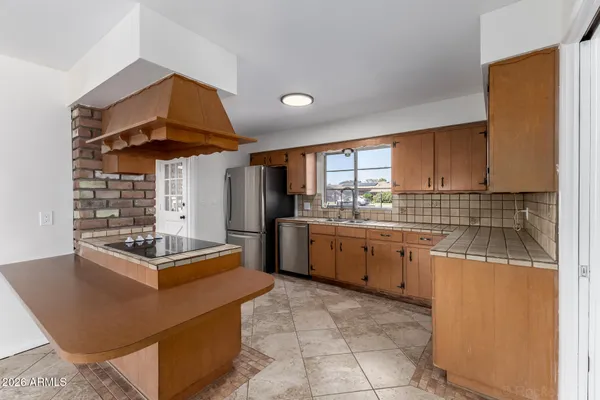 a spacious bedroom with a large bed and a chandelier