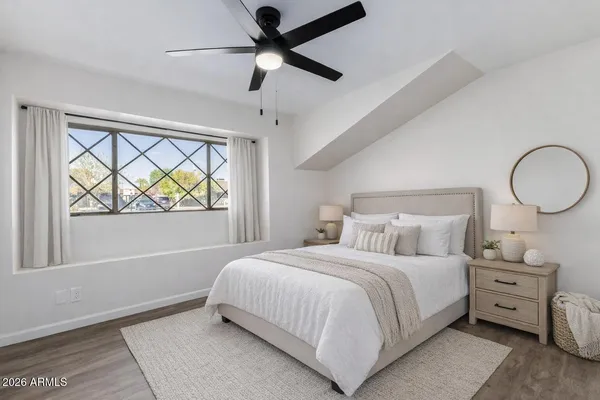 a bedroom with a large bed and a window