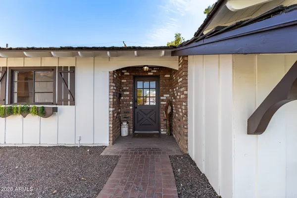 a living room with furniture a rug and a ceiling fan
