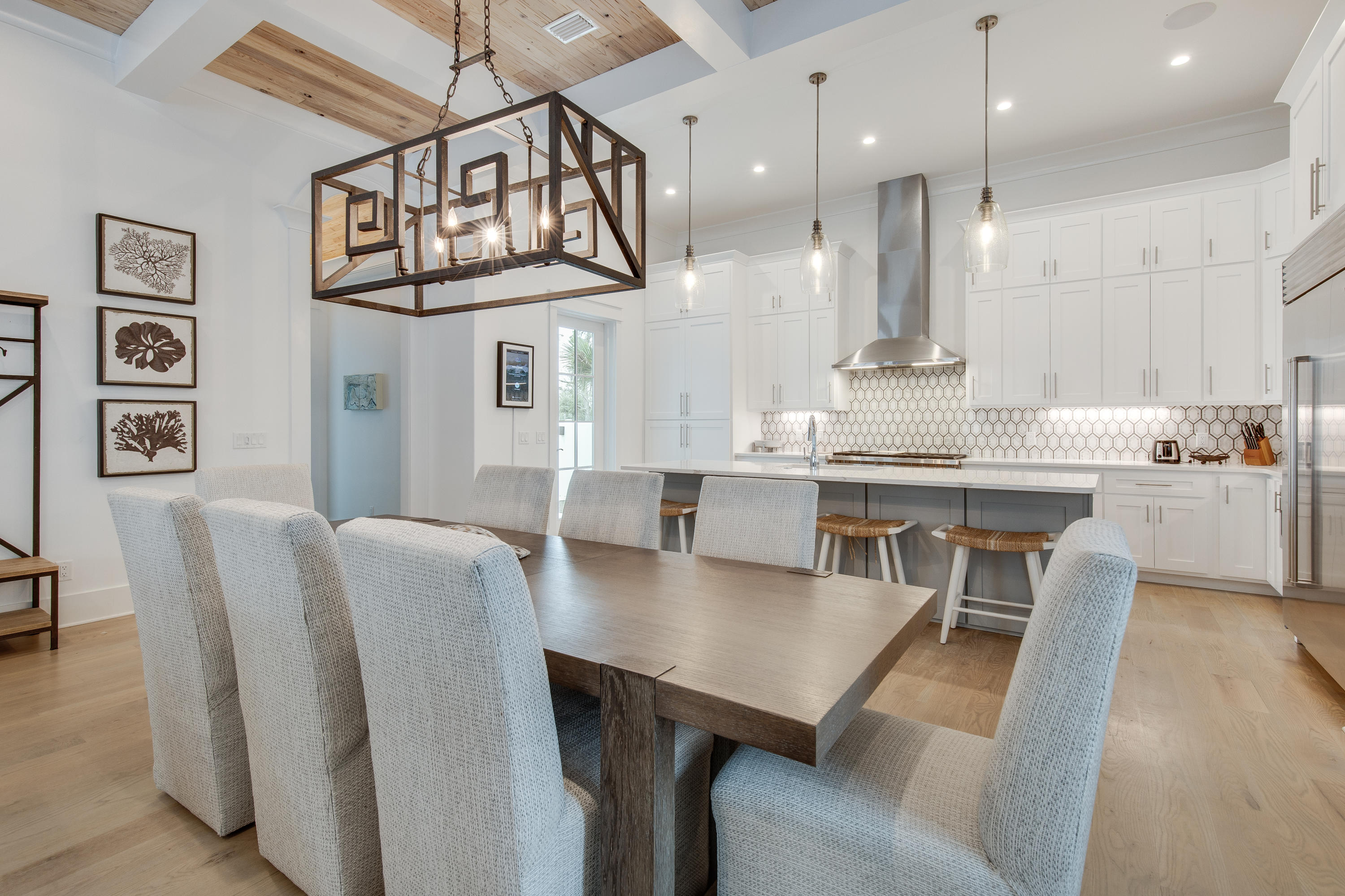 94 Pine Crest Circle Rosemary Beach, FL 32461 - Photo 12 of 69 a kitchen with stainless steel appliances kitchen island granite countertop a dining table chairs and a refrigerator