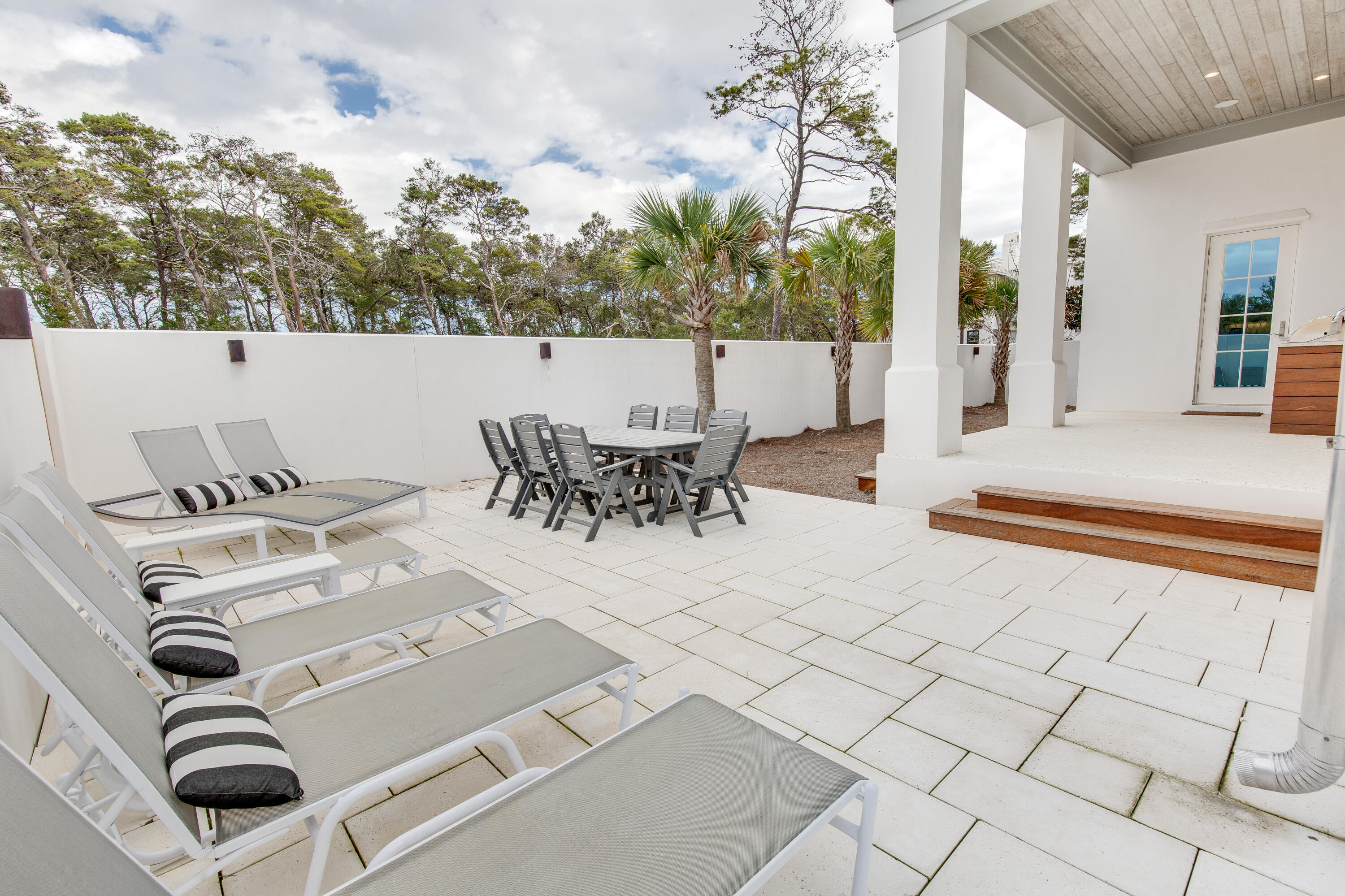 94 Pine Crest Circle Rosemary Beach, FL 32461 - Photo 51 of 69 a view of a patio with a table and chairs