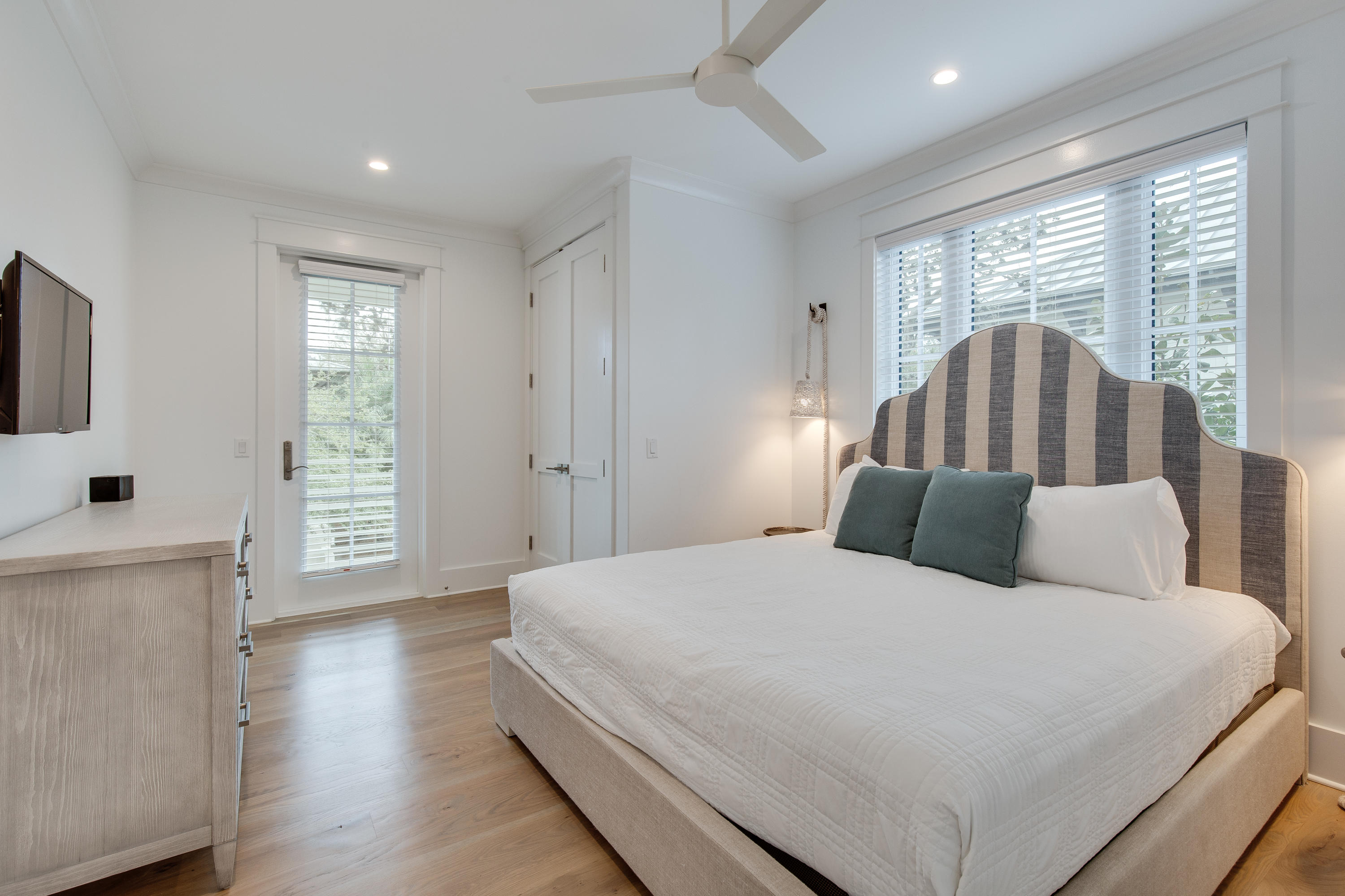 94 Pine Crest Circle Rosemary Beach, FL 32461 - Photo 56 of 69 a bedroom with a large bed and a flat tv screen on dresser